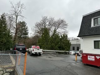 a parking lot with cars and trees