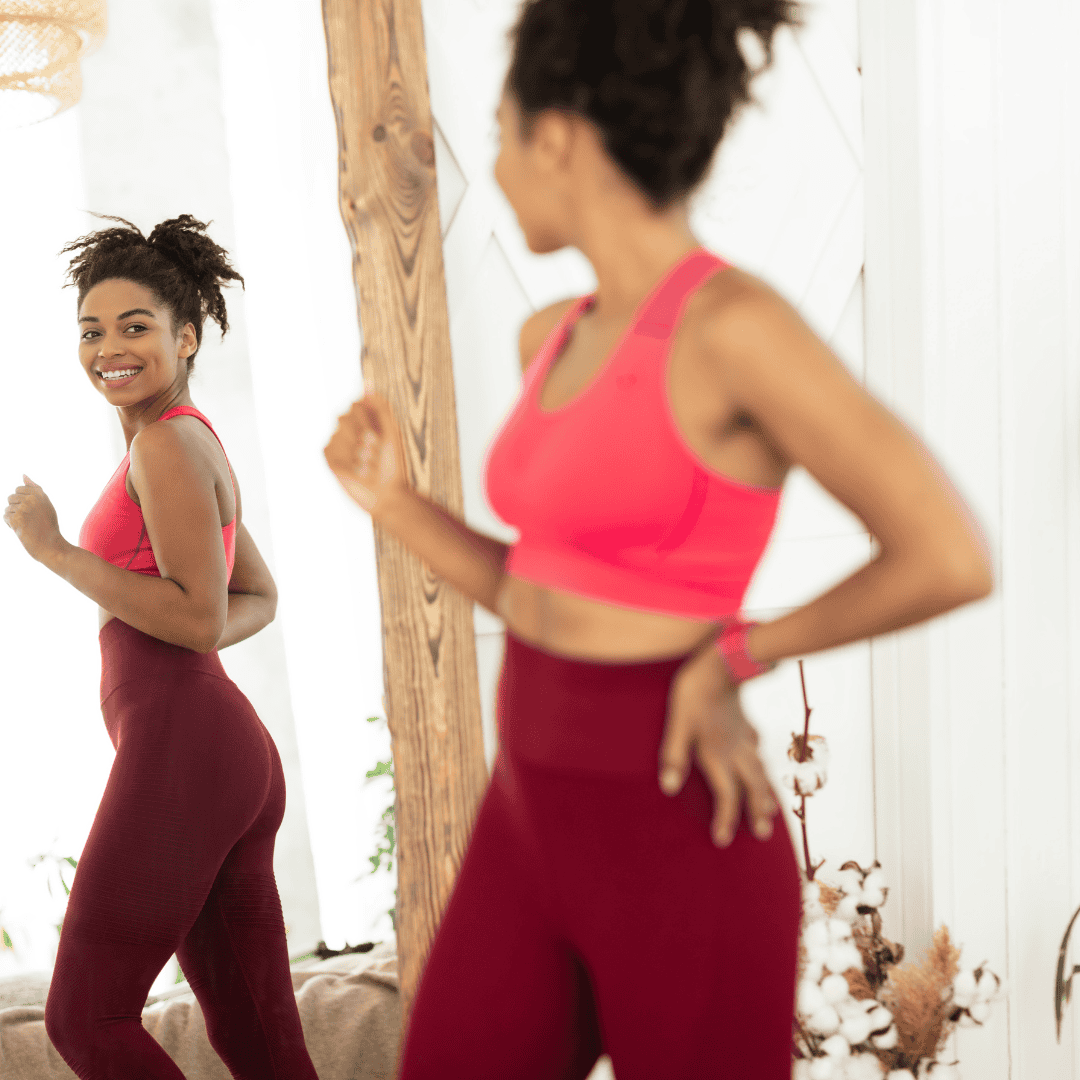 a woman in red running clothes inspecting weight loss