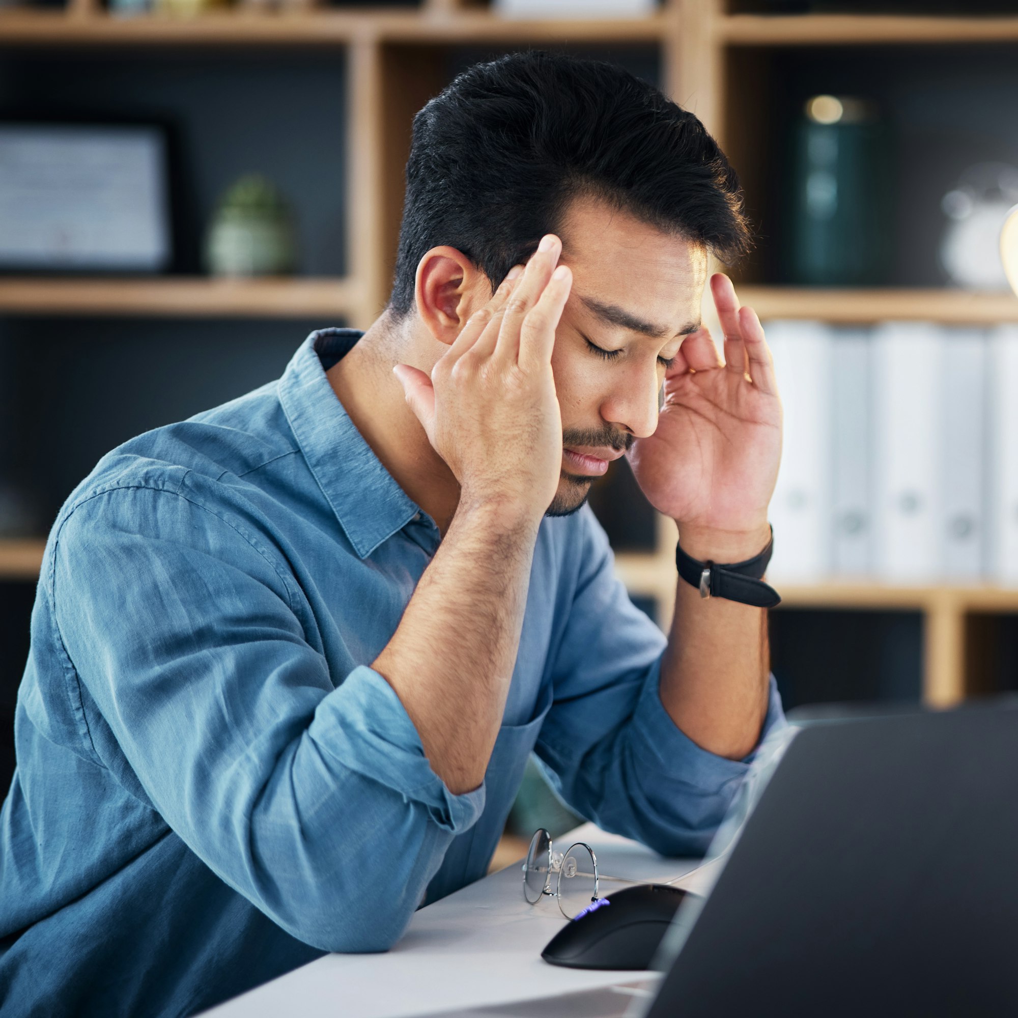 Migraine, headache and tired man with career stress, depressed or mental health risk in office mana